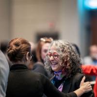 Dean Diana Lawson interacting with someone at the West Michigan Economic Forecast